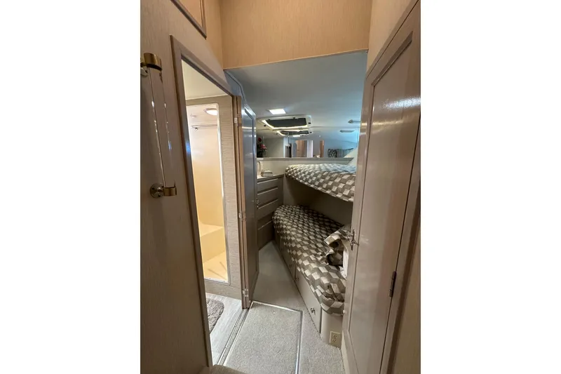 Slide: The Image of Interior of 1992 Hatteras 65 Motor Yacht with bunk beds and bathroom. - 26