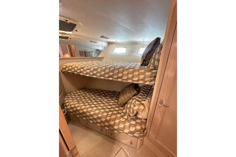 Slide: The Image of Bunk beds in 1992 Hatteras 65 Motor Yacht cabin with patterned bedding. - 27