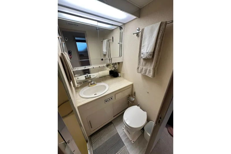 Slide: The Image of Bathroom interior of 1992 Hatteras 65 Motor Yacht with sink, mirror, and toilet. - 28