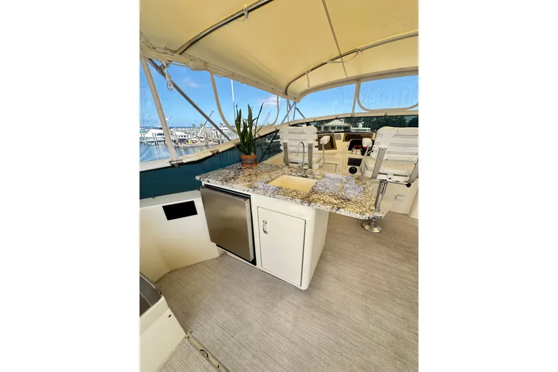 Slide: The Image of Luxurious 1992 Hatteras 65 Motor Yacht interior with granite countertop and seating area. - 33