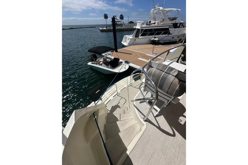 Slide: The Image of 1992 Hatteras 65 Motor Yacht docked, with view of water and nearby boats. - 36