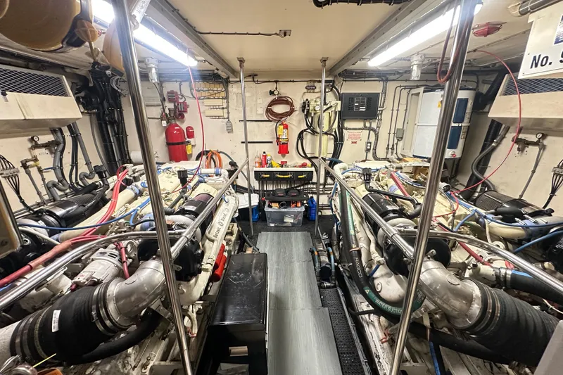 Slide: The Image of Engine room of a 1992 Hatteras 65 Motor Yacht, showcasing dual engines and equipment. - 37