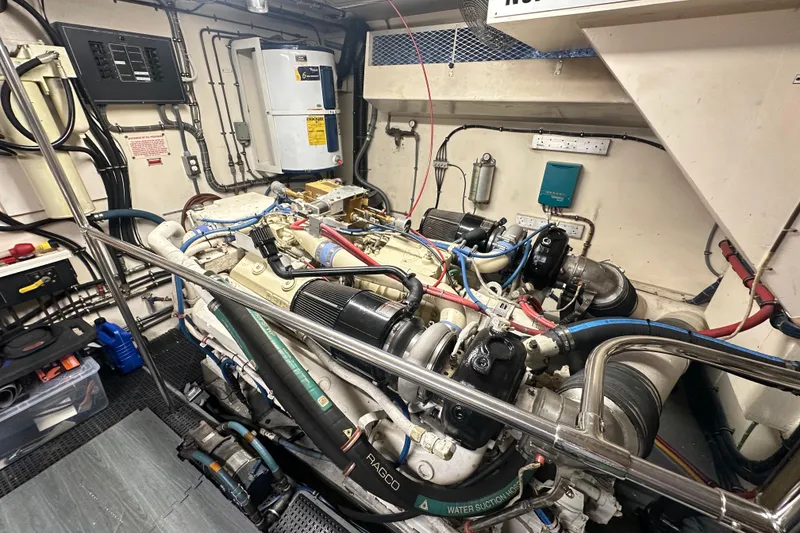 Slide: The Image of Engine room of a 1992 Hatteras 65 Motor Yacht, showcasing detailed machinery and components. - 39