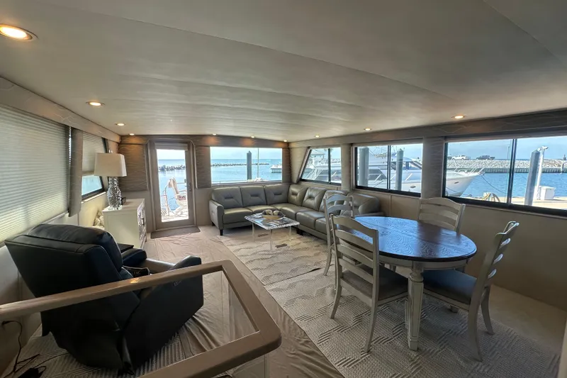 Slide: The Image of Luxurious interior of 1992 Hatteras 65 Motor Yacht with elegant seating and dining area. - 4