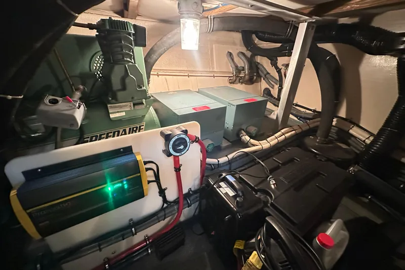 Slide: The Image of Engine room of a 1992 Hatteras 65 Motor Yacht with machinery and wiring. - 43