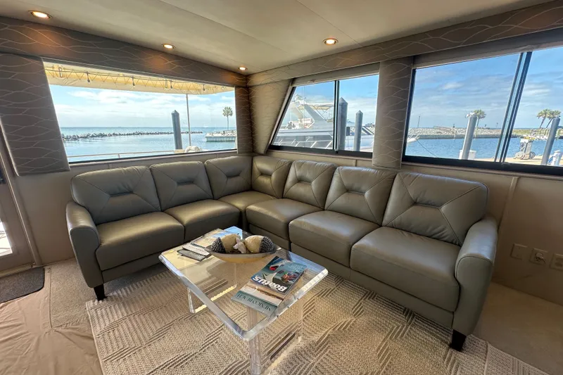 Slide: The Image of Luxurious interior of 1992 Hatteras 65 Motor Yacht with leather seating and ocean view. - 5