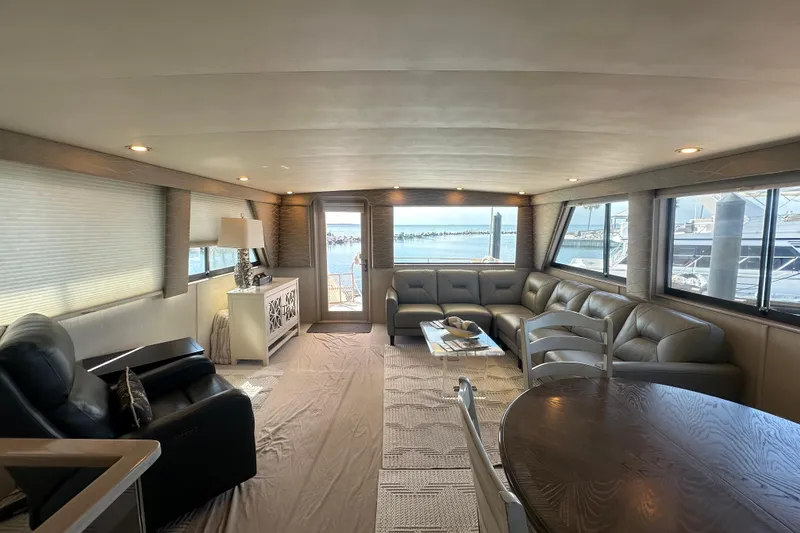 Slide: The Image of Luxurious interior of a 1992 Hatteras 65 Motor Yacht with elegant seating and ocean views. - 6