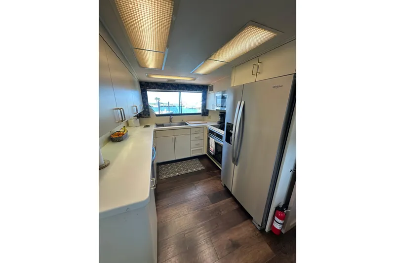 Slide: The Image of Kitchen interior of 1992 Hatteras 65 Motor Yacht with modern appliances and wood flooring. - 8