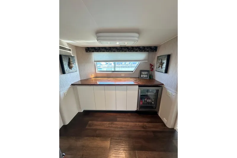 Slide: The Image of Interior of 1992 Hatteras 65 Motor Yacht with modern kitchenette and wood flooring. - 9