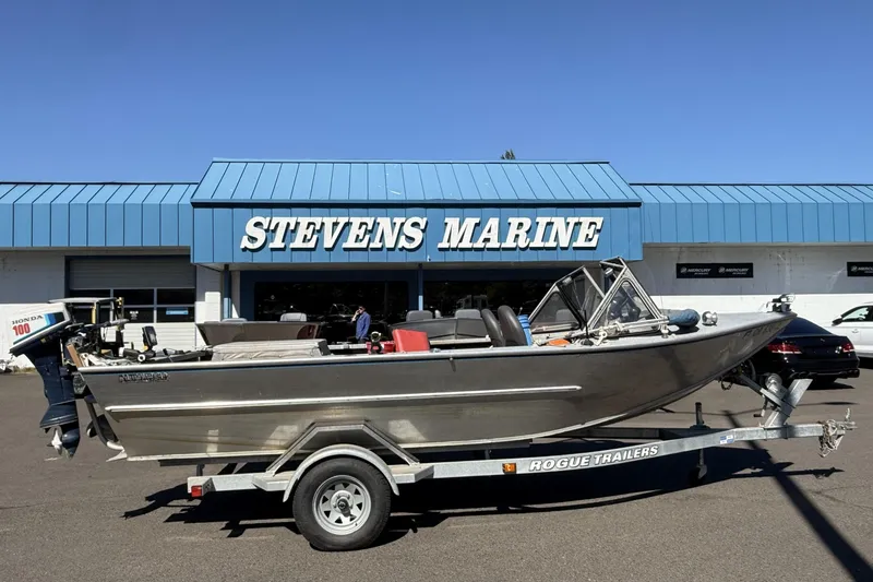 The Image of 1977 Alumaweld Inboard Jet boat on trailer outside Stevens Marine. - 1