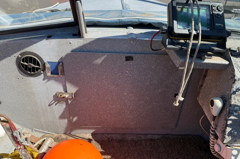 Slide: The Image of 1977 Alumaweld Inboard Jet boat interior with navigation equipment and orange buoy. - 12