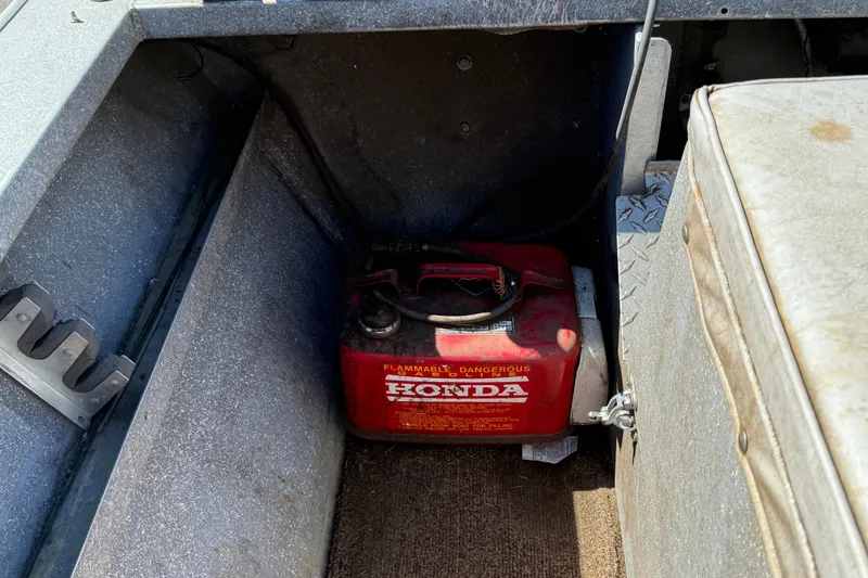 Slide: The Image of 1977 Alumaweld Inboard Jet boat interior with a red Honda fuel container. - 19