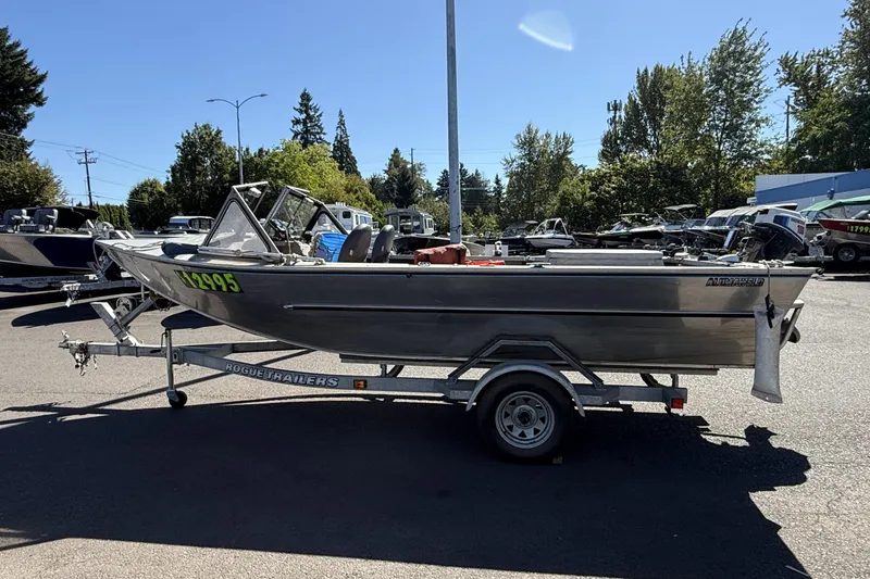 Slide: The Image of 1977 Alumaweld Inboard Jet boat on trailer in sunny outdoor setting. - 4