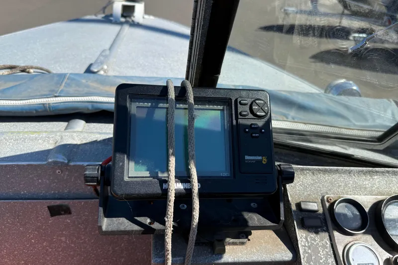 Slide: The Image of 1977 Alumaweld Inboard Jet boat dashboard with sonar device and controls. - 7