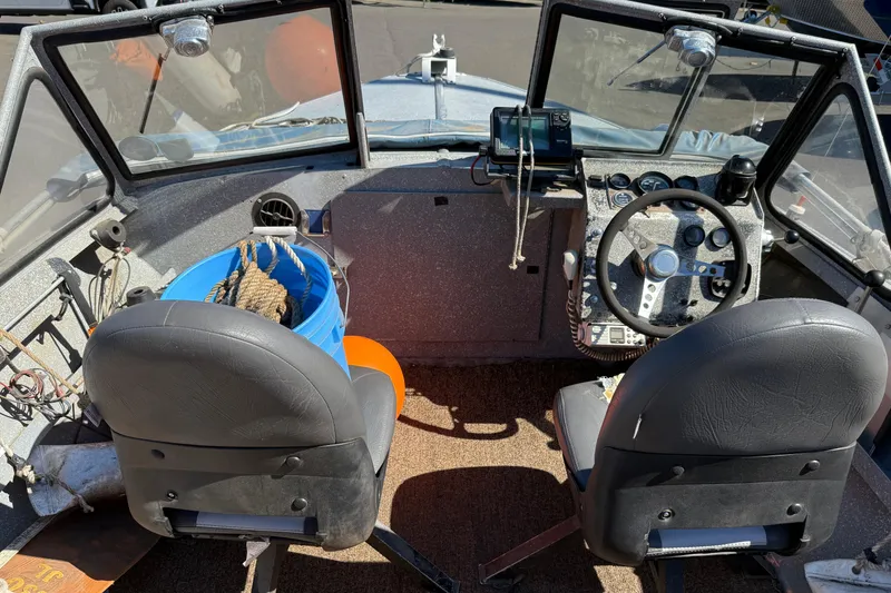 Slide: The Image of 1977 Alumaweld Inboard Jet boat interior with steering wheel and equipment. - 8