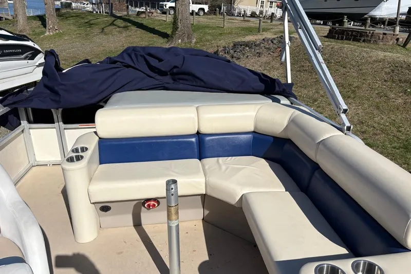 Slide: The Image of 2006 Triton 220 F Gold boat interior with cushioned seating and cup holders. - 3