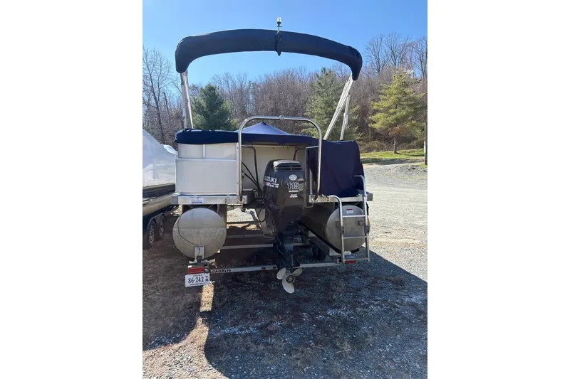 Slide: The Image of 2006 Triton 220 F Gold pontoon boat with Suzuki 115 outboard motor on trailer. - 8