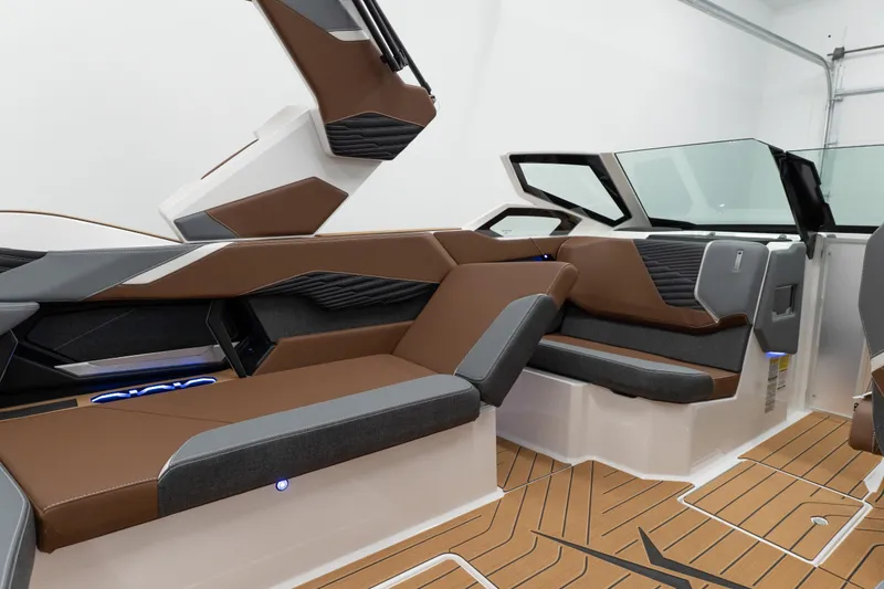 Slide: The Image of 2026 MasterCraft X24 boat interior with brown and gray seating, modern design. - 12