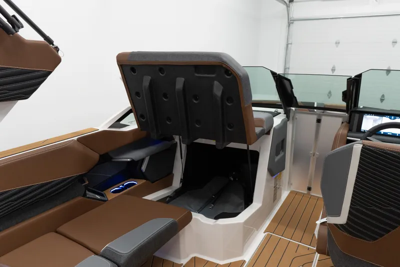 Slide: The Image of 2026 MasterCraft X24 boat interior with brown seating and modern dashboard design. - 14
