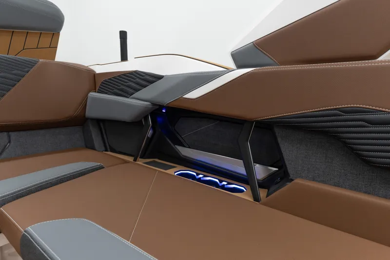 Slide: The Image of 2026 MasterCraft X24 interior with brown and gray seating, featuring modern design and ambient lighting. - 15