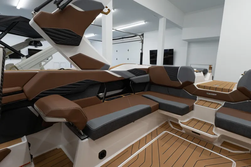 Slide: The Image of 2026 MasterCraft X24 boat interior with luxurious brown and gray seating. - 16