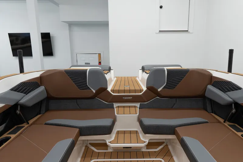 Slide: The Image of 2026 MasterCraft X24 boat interior with brown and gray seating, modern design. - 17