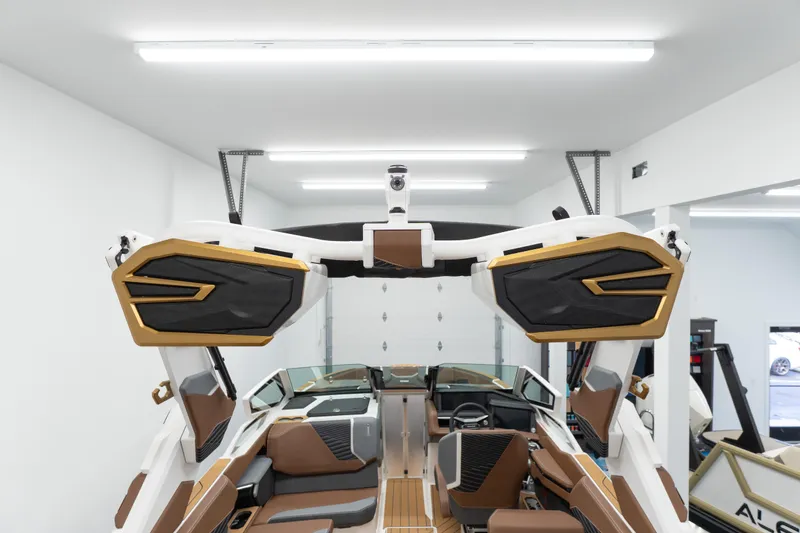 Slide: The Image of 2026 MasterCraft X24 boat interior with modern design and premium features in a well-lit garage. - 21