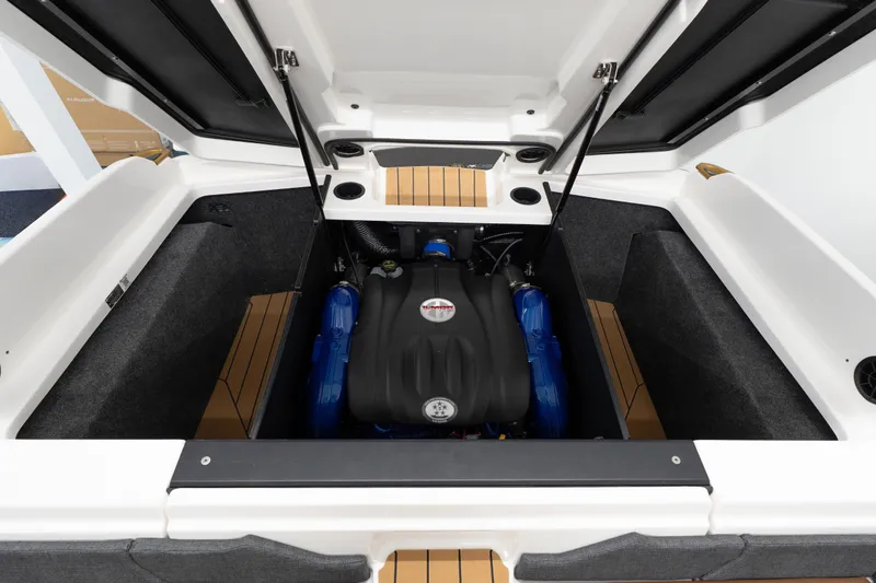Slide: The Image of 2026 MasterCraft X24 boat engine compartment with open hatches and visible components. - 23