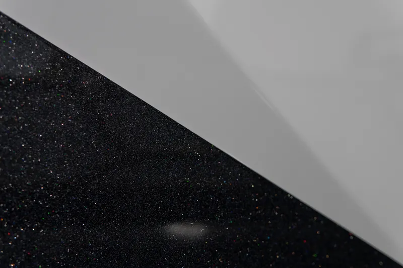 Slide: The Image of 2026 MasterCraft X24 boat with sleek black and white exterior design. - 26