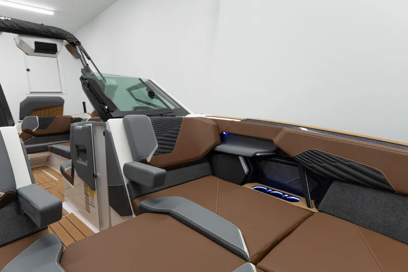 Slide: The Image of 2026 MasterCraft X24 boat interior with brown and gray seating, modern design features. - 3