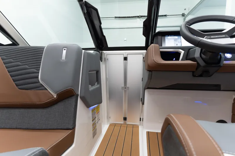 Slide: The Image of Interior of 2026 MasterCraft X24 boat, featuring modern seating and steering wheel design. - 5