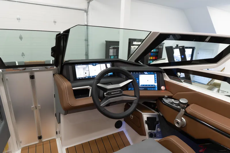 Slide: The Image of 2026 MasterCraft X24 boat interior with modern dashboard and steering wheel. - 6