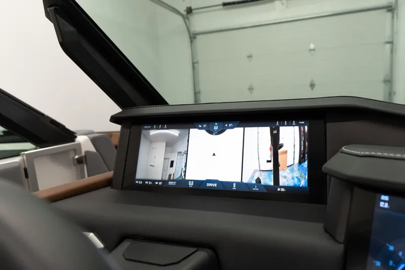 Slide: The Image of 2026 MasterCraft X24 dashboard with advanced touchscreen display in a garage setting. - 8