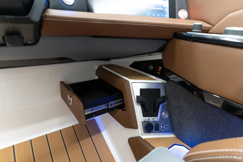 Slide: The Image of Interior of 2026 MasterCraft X24 boat with open storage compartment and control panel. - 9