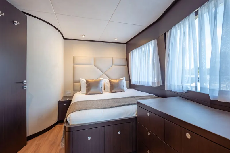 Slide: The Image of Luxurious bedroom interior of 2025 Hargrave E Series yacht with elegant furnishings and natural light. - 26