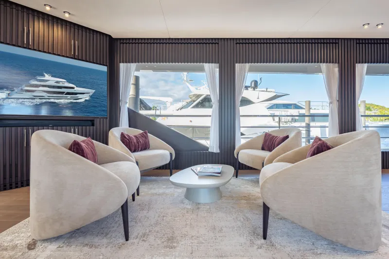 Slide: The Image of Luxurious Hargrave E Series 2025 yacht interior with elegant seating and scenic window views. - 4