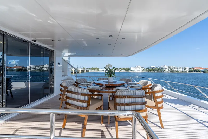 Slide: The Image of Luxurious 2026 Hargrave E Series yacht deck with elegant dining setup overlooking serene waters. - 41
