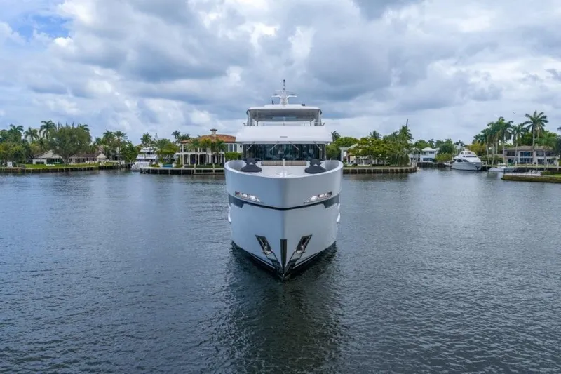 Slide: The Image of Front view of 2026 Hargrave E Series yacht on a calm waterway. - 55