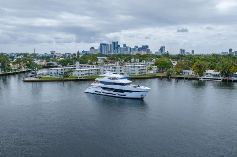 Slide: The Image of Luxurious 2026 Hargrave E Series yacht cruising near a city skyline under cloudy skies. - 56