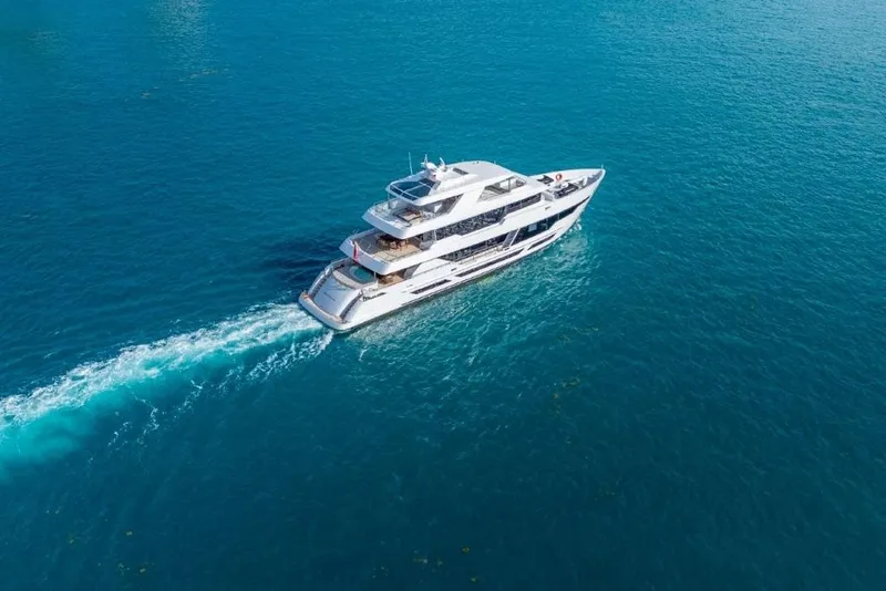 Slide: The Image of Luxurious 2026 Hargrave E Series yacht cruising on clear blue ocean waters. - 61
