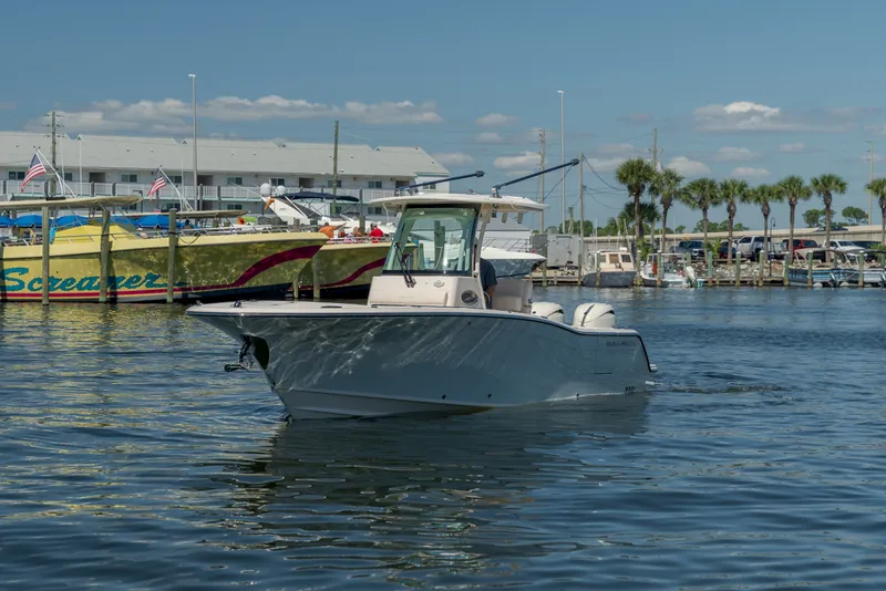 Slide: The Image of A 2027 Grady-White Canyon 266 boat cruising on calm waters in a marina. - 7