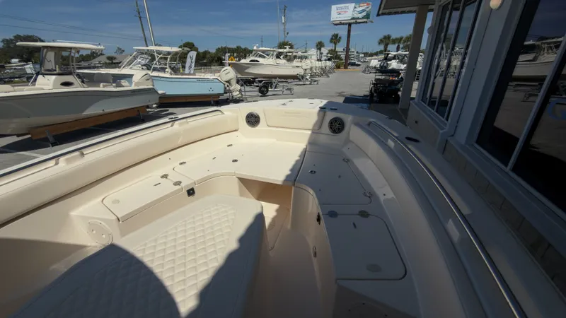 Slide: The Image of The image shows the spacious bow area of a Grady-White Canyon 266 boat at a marina. - 14