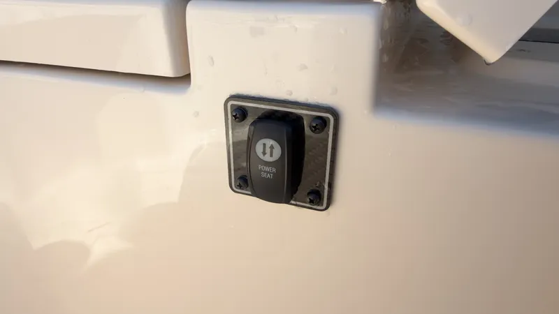 Slide: The Image of Close-up of a switch labeled "Power Seat" on a boat. - 13