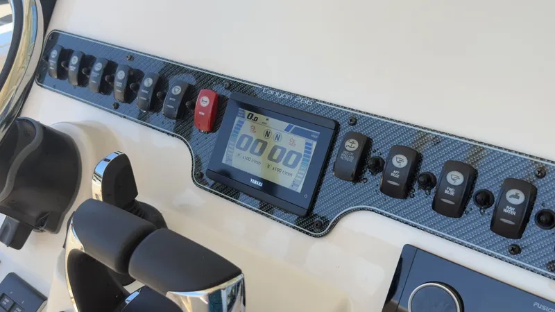 Slide: The Image of The image shows the dashboard of a Grady-White Canyon 266 boat with modern controls. - 24