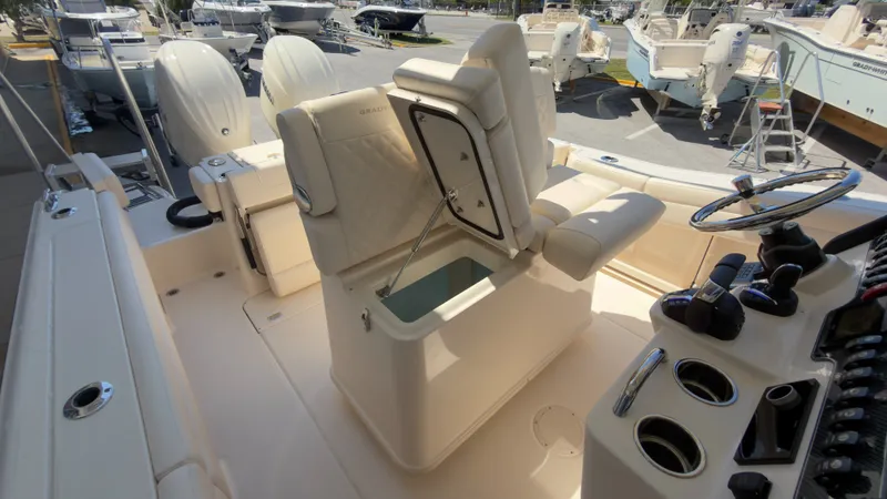 Slide: The Image of The image shows the cockpit of a Grady-White Canyon 266 boat with helm and seating. - 32