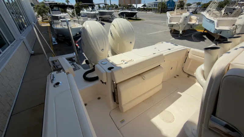 Slide: The Image of The image shows the stern of a Grady-White Canyon 266 boat with two outboard engines. - 35