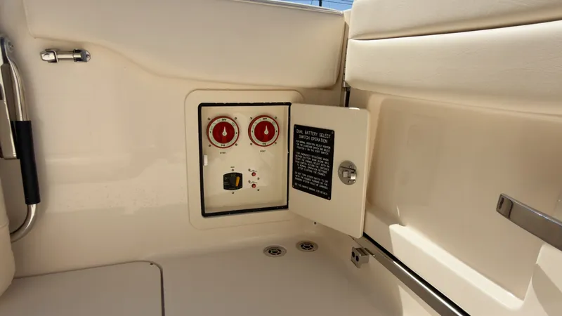 Slide: The Image of An open control panel with two red dials and a switch on a boat. - 40
