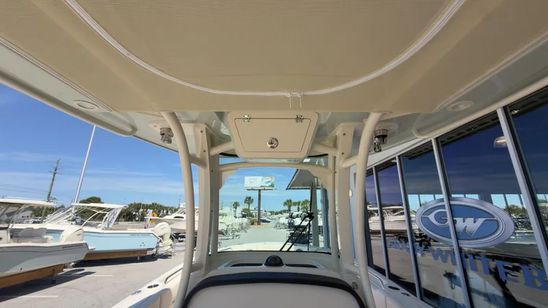 Slide: The Image of The image shows the cockpit of a Grady-White Canyon 266 boat with a sturdy roof. - 21