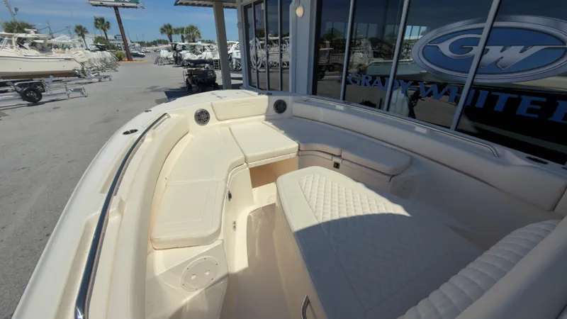 Slide: The Image of The image shows the bow area of a Grady-White Canyon 266 boat with cushioned seating. - 11