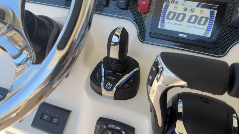 Slide: The Image of Close-up of a Grady-White Canyon 266 helm with modern controls and a display. - 28